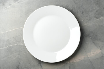 White empty plate on gray background top view