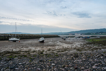 Small boats moored in the harbour at Rhos-on-Sea, Wales, Uk at low tide.