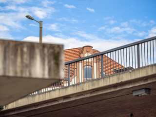 Concrete structure with a railing, a streetlamp, and a detailed building