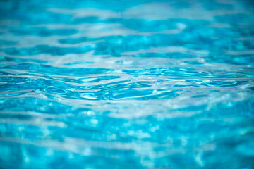 Water background, ripple waves. Blue swiming pool pattern. Sea surface. Water in swimming pool with...