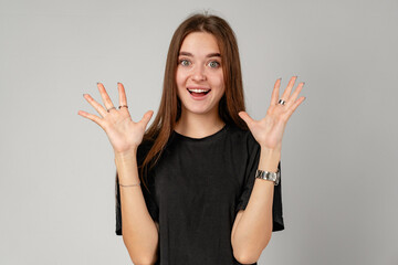 Young Woman Showing Surprise Expression on Gray Background