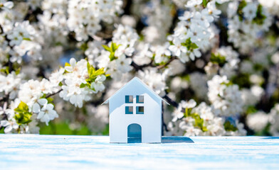 The symbol of the house stands against a background of cherry blossoms
