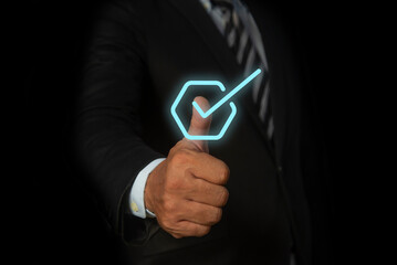 Businessman hand thumb up with virtual correct sign or tick mark. Standardization and certification...