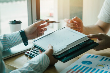 person happily extending their hand to sign a critical business agreement, highlighting the...