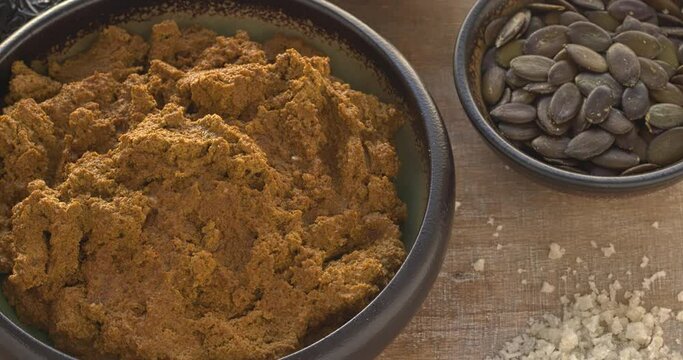 Mexican sauce Pipian Tlatonile. The sauce's main ingredients are sesame seeds, pumpkin seeds, dried chilies, olive oil, and salt. Table spin