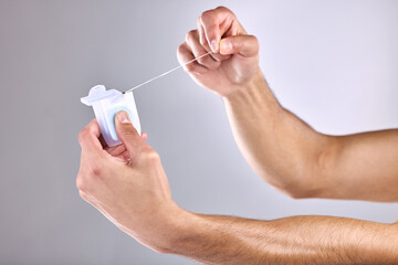 Dental floss, hands and man in studio with clean, health and plaque removal morning routine....