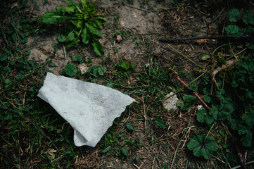A discarded napkin on the grass in the park