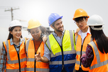 In the Industrial Engineering Facility: Diverse Group of Engineers, Technicians, and Specialists on a Meeting, Have Discussion, Analyse Engine Design Technical Drafts that are Lying on the Table