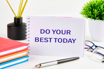 Business motivational. Do your best today symbol on a standing notebook on a white background