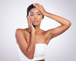 Obraz premium Skincare, model and face for beauty, dermatology and routine facial treatment. Spa, wellness and skin glow aesthetic on white studio background with black woman, cosmetics and luxury collagen shine