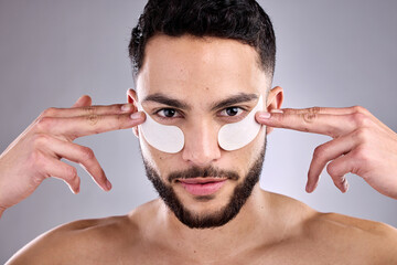 Beauty, eye mask and portrait of man in studio for antiaging skincare treatment or wellness....