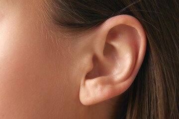Close-up of female ear without jewels. Taking care after health, visiting doctors, check up....