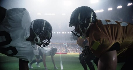 Intense Moments From An American Football Match Played Under Heavy Rain, with Gridiron Players Tackle and Execute Plays. Teams Compete on the Field in a Sports Battle for Tournament Glory