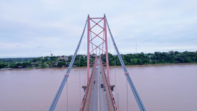 Embark on an exciting drone flight between the cables of Puerto Maldonado's iconic bridge. At the end, reveal the majesty of this Amazonian city in a stunning aerial shot