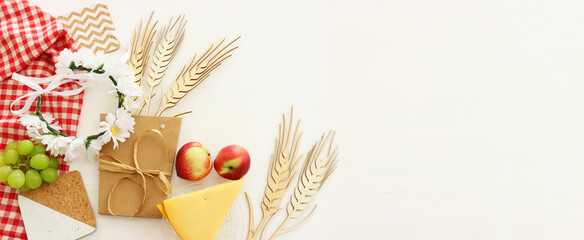 Photo of dairy products over wooden white background. Symbols of holiday - Shavuot