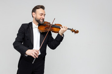 Elegant man violinist on stage performing concert