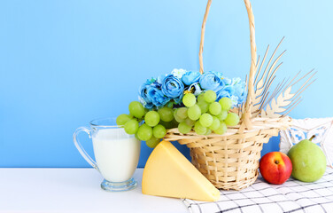 Photo of dairy products over blue background. Symbols of holiday - Shavuot