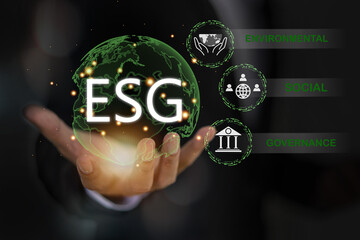 Businessman hold ESG icon of saving clean energy environmental, social, governance, sustainable and...