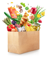 Food or groceries flying out from paper shopping bag on white background. File contains clipping...