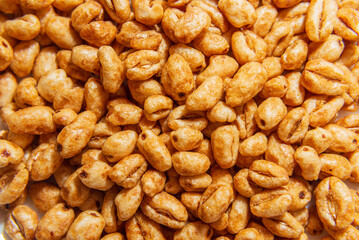 caramel wheat dry cereal for breakfast macro closeup background.
