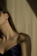 Portrait of a beautiful young woman with earrings. Stylish brunette model with natural beauty wearing minimalist earrings with pearls. Luxury fashion. Fashion blog. Website images. Advertising images.