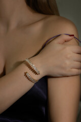 Luxury concept. Hot girl with golden bracelet. Event jewels. Wedding accessories. Beautiful young girl with diamonds bracelet. Trendy Minimalistic style.Stylish accessories.Jewelry fashion photography