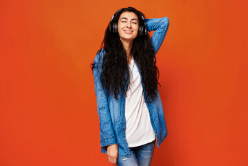 Young woman on orange background