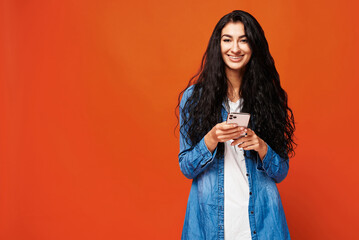 Young woman on orange background