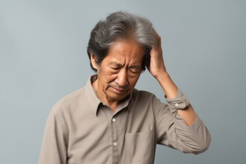 Cream background sad Asian man. Portrait of older mid-aged person beautiful bad mood expression boy Isolated on Background depression anxiety fear burn out health issue 