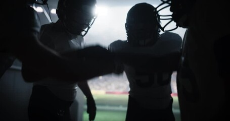 Tunnel Walk with a Group of American Football Players with Strong Team Spirit Entering a Sold Out Arena Before a Championship Match. Footballers Welcomed Like Superstars by International Sport Fans
