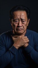Indigo background sad Asian man. Portrait of older mid-aged person beautiful bad mood expression boy Isolated on Background depression anxiety fear burn out health issue problem