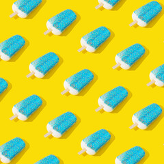 Trendy sunlight blue glazed ice cream popsicle pattern on yellow background. Minimal summer concept. Ice cream aesthetic.