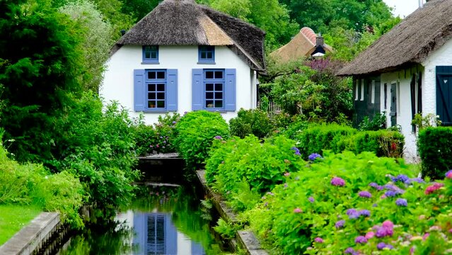 Traditional waterfront Dutch house on a canal in the village of Giethoorn, Netherlands.