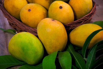 Fresh Mango tropical fruit with green leaf, Ripe mango in grass.