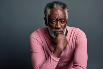 Peach background sad black American independent powerful man. Portrait of older mid-aged person beautiful bad mood expression isolated on background racism 