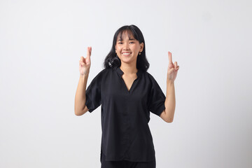 Portrait of attractive Asian woman in casual shirt sweating with her hand on her chest and fingers up, making an oath of loyalty. Isolated image on white background