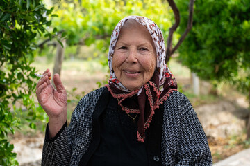 An old woman holding a cigarette.