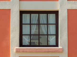 window with white curtains and a brown frame