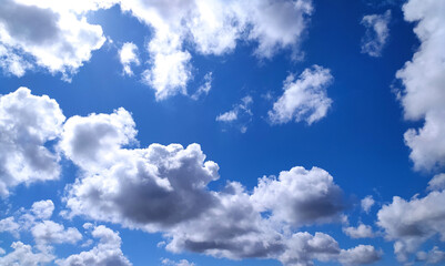 Fototapeta premium Clear blue sky texture and white fluffy cloud nature background. The sun shines bright in the daytime in summer