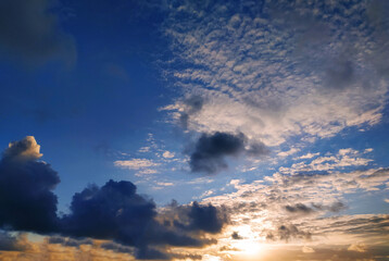 Sun Setting Over Clouds in Sky