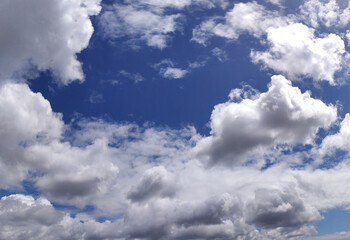 Clear blue sky texture and white fluffy cloud nature background. The sun shines bright in the daytime in summer