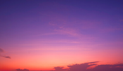 Colorful twilight sky background with beautiful pink and orange cloud on idyllic blue evening sky,...