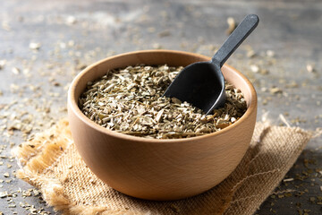 Traditional yerba mate in bowl on wooden table