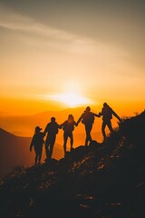 People holding hands and working together to climb to the top of a mountain where the sunrise rises