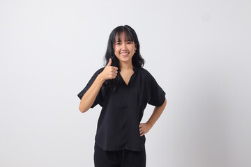 Portrait of attractive Asian woman in casual shirt making thumb up hand gesture, saying good job. Businesswoman concept. Isolated image on white background