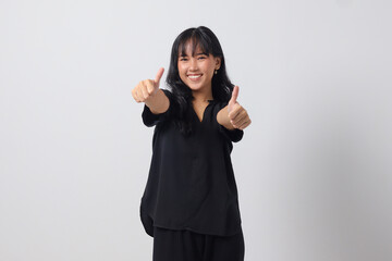 Portrait of attractive Asian woman in casual shirt making thumb up hand gesture, saying good job. Businesswoman concept. Isolated image on white background