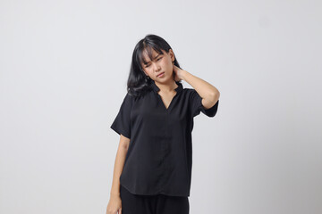 Portrait of unhealthy Asian woman in casual shirt touching her neck and feeling exhausted after work. Businesswoman concept. Isolated image on white background