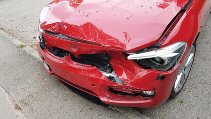 red accident car with dented bonnet, head-on collision