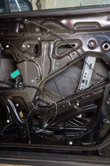 An automotive speaker is installed in a car door for audio equipment