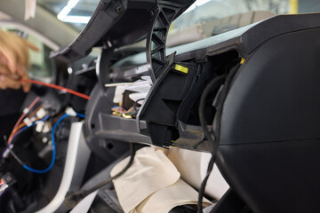 Fototapeta premium Individual is performing maintenance on the vehicles dashboard